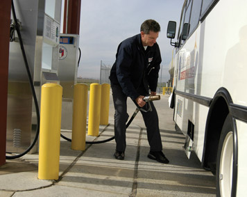 Image of man filling up a bus
